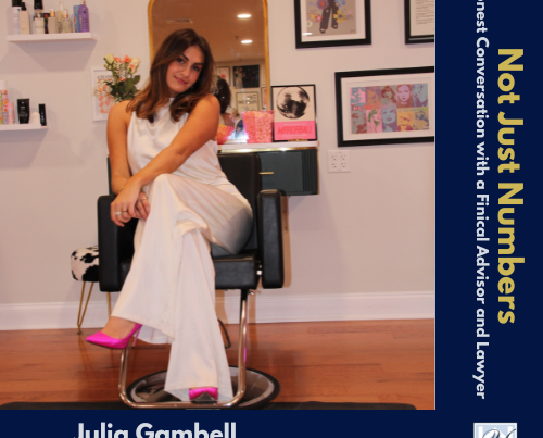 A photo showing Julia Gambell, owner of Salon J Raine Madison, seated in a styling chair in her salon's stylishly decorated interior space.