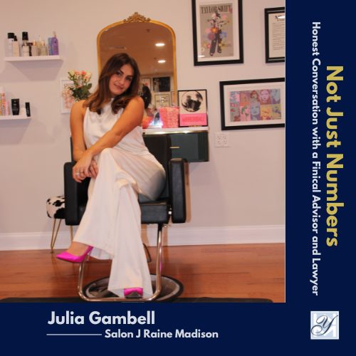 A photo showing Julia Gambell, owner of Salon J Raine Madison, seated in a styling chair in her salon's stylishly decorated interior space.